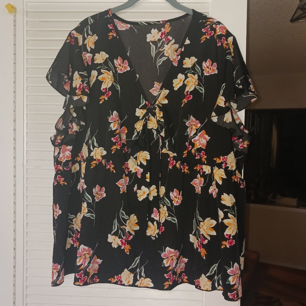 Flowing black blouse with flowers and front bow detail. Plus size